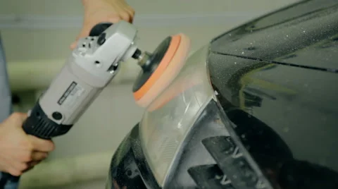Close up shot worker polish car headlight with special tools Stock Footage 65758634