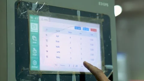 Close Up Shot Of A Worker Programming A CNC Machine Using A Computer Display 動画素材 332815338