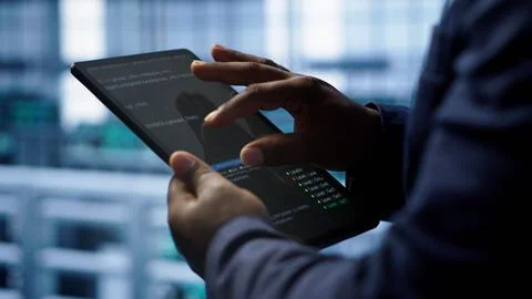 Close up shot of worker in server room using tablet Stock Photos
