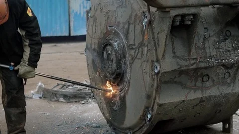 Close up shot of worker trying to cut part of road leveller. Stock Footage 81817590