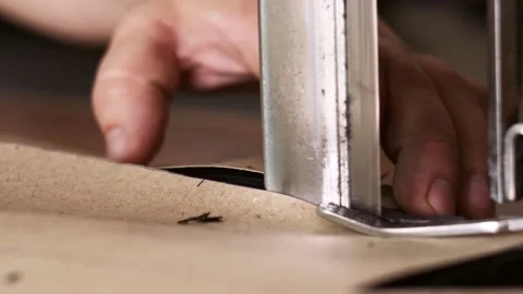 Close shot of Worker's hands on a sewing manufacture control electric cutting Stock Footage 151168678