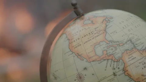 Close up Shot of a World Globe in Front of an Outdoor Fire with Bokeh Effect 動画素材 208803498