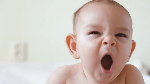 Close-up shot of yawning baby Portrait of sleepy child of six months old nap  Stock Footage