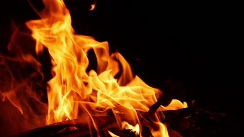 Close shot of yellow fire flames with black background 動画素材 150715163