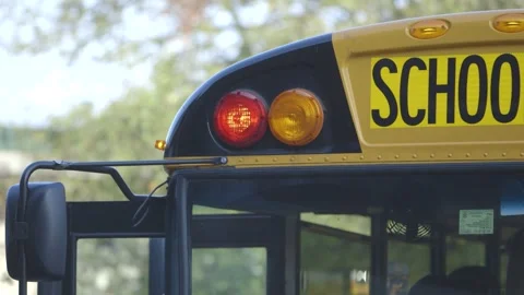Close up shot of yellow school bus, blinking red light, open door Stock Footage 304371672