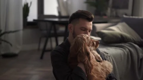 Close up shot of young bearded man hugging his cute dog. Stock Footage 169043414