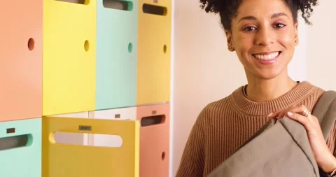 Close up shot of young biracial student packing books into backpack, college Stock Footage 244535979