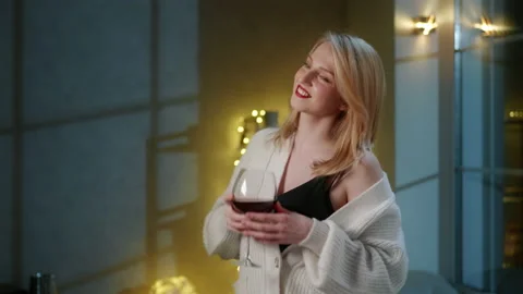 Close-up shot of young, blonde-haired woman celebrating winter holidays indoors Stock Footage 229296809