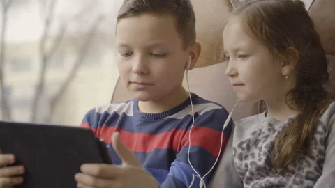 Close-up shot of a young boy and girl traveling by bus through city, watching Stock Footage 89231289