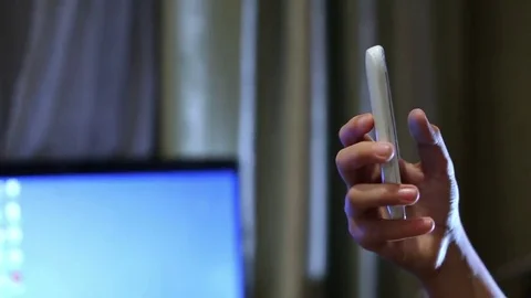 Close up shot of young boy playing on smart phone. The boy's thumbs are swiping Stockbeeldmateriaal 69171588