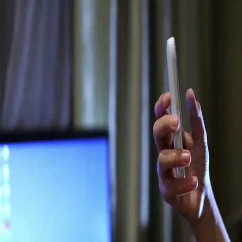 Close up shot of young boy playing on smart phone. The boy's thumbs are swiping Stock Footage 69556124