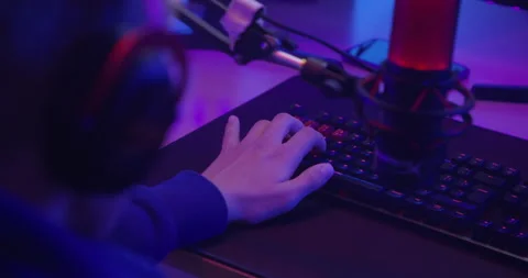 Close up shot, young boy is playing games on computer in his room, RGB lights am Stock Footage 141923993