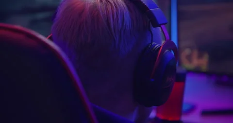 Close up shot, young boy is playing games in his room, RGB lights ambient. Gamin Stock Footage 141932342