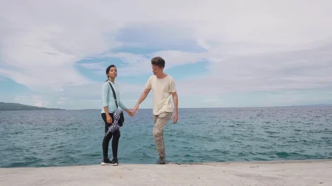 Close up shot of young couple on the the boulevard holding hands and walking. Stock Footage 115804284
