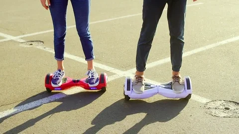 Close up shot of young couple while riding hover board Stock Footage 74691217