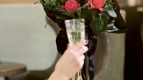 Close-up shot of the young man and woman clinking of glasses with white wine. 4K Stock-Footage 87724369