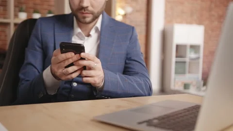 Close-up shot of: a young man doing something on his smartphone then smiling Stock-Footage 191882142