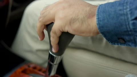 Close up shot Young man hand control the stick shift transmission in luxury car. Stock Footage 161301691