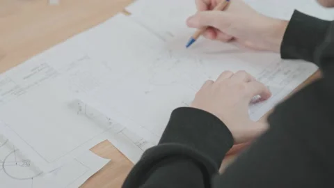 Close-up shot of young man sitting at desk, drawing drone. Guy holding pen in 動画素材 186163067
