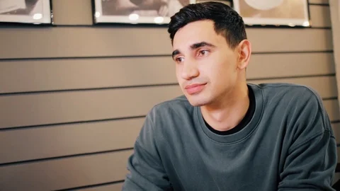 Close shot of young man smiling in cafe Stock Footage 118214307