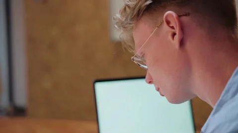 Close-up shot of young man studying at home writing notes Stock Footage 164372643