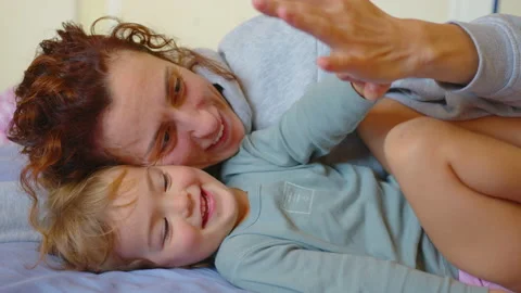 Close up shot of young mother is playing with her baby in a nursery in a morning Stock Footage 219287759