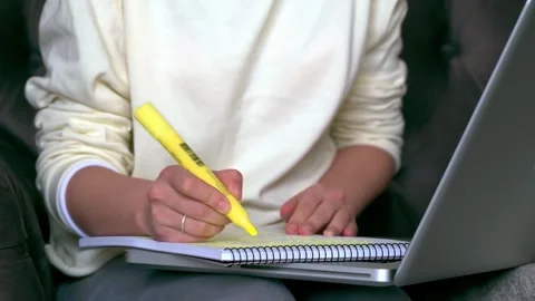 A close-up shot of a young student highlighting important information in he.. Stock Footage 339766716