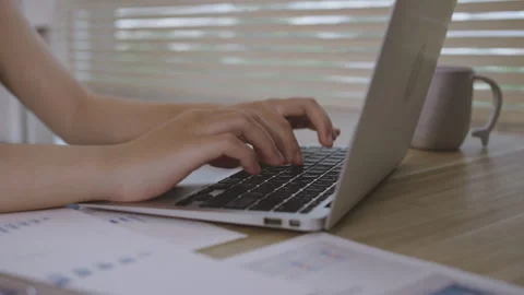 Close-up shot of young woman's hand pressing on laptop keyboard, Use of compu Stock Footage 249951209
