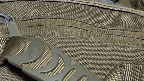 A close-up shot of a zipper on a backpack, suitable for use in travel, adve.. Video stock 347447932