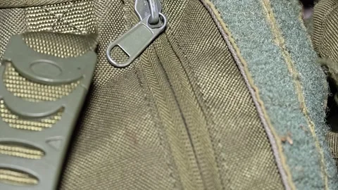 A close-up shot of a zipper on a backpack, suitable for use in travel, adve.. Video stock 347447936