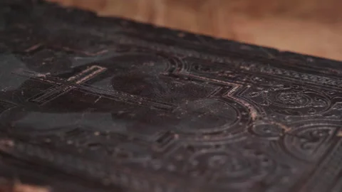 Close-up shots of an antique Bible with a cross Stock Footage 290014432