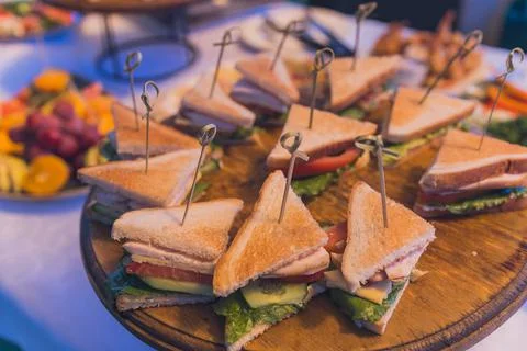 Close up shots of assorted sandwich triangles on a catering party platter. 스톡 사진