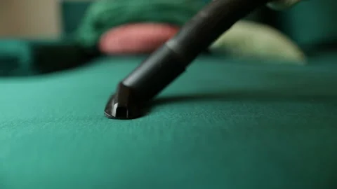Close-up shots of cleaning the sofa with a vacuum cleaner. Stock Footage 237840375