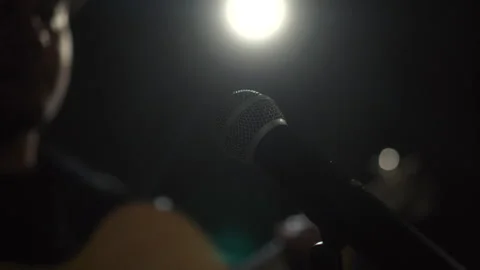 Close up shots of microphone singer man singing music and playing guitar on stag Stock Footage 241100544