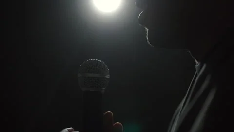 Close up shots microphone speaker man talking on stage with spotlight strike. Stock Footage 241084975