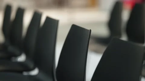 Close-up shots of rows of modern black plastic chairs in an empty conference Stock Footage 325671548