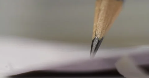 Close-up shots of a sharpened pencil writing on crumpled paper, showcasing the Stock Footage 317557721