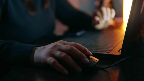 Close-up shots of women's hands using a laptop and a mouse in the evening Stock Footage 238434679