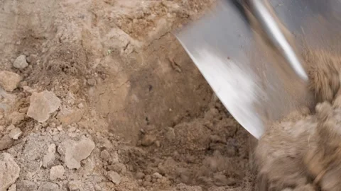 Close-up of a shovel digging the soil of a vegetable garden bed Video stock 311520692