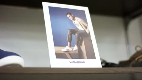 A close up showcase with a camera floating of a photograph standing on a shelf Stock Footage 143726096