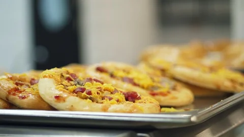 Close-up, showcase with mini pizza, yeast dough baking in modern canteen Stock Footage 103578663