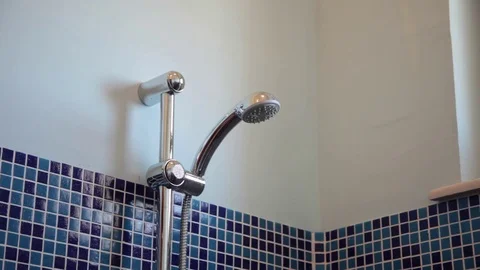 Close up of a shower head turning on and off Stock Footage 70572895