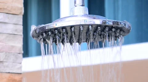 A close-up of a shower head turning on. Stock Footage 51314154
