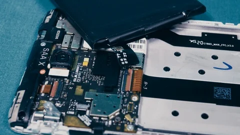 Close-up shows a disassembled smartphone Stock Footage 101343095