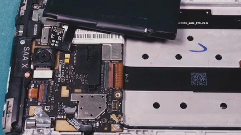 Close-up shows a disassembled smartphone Stock Footage 101343137
