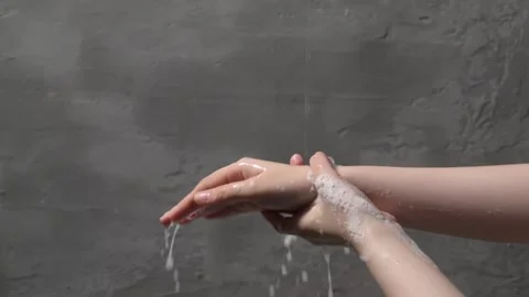 A close-up shows hands being thoroughly washed with soap and water, emphasi.. Stock Footage 304213283