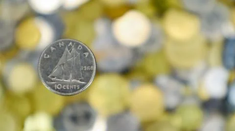 A close-up shows one 10-cent coin. This is money. Blurred money background. D Stock Photos