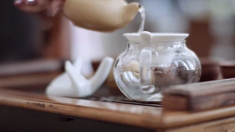 Close-up shows the tea ceremony, the tea is poured into a special glass vessel Stock Footage 111384261