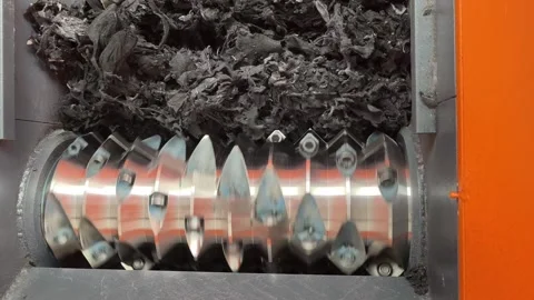 Close-up of shredder blades rotating to grind material Stock Footage 346812936