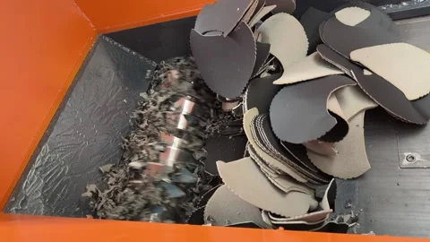 Close-up of shredder blades rotating to grind foam scrap Stock Footage 346812962